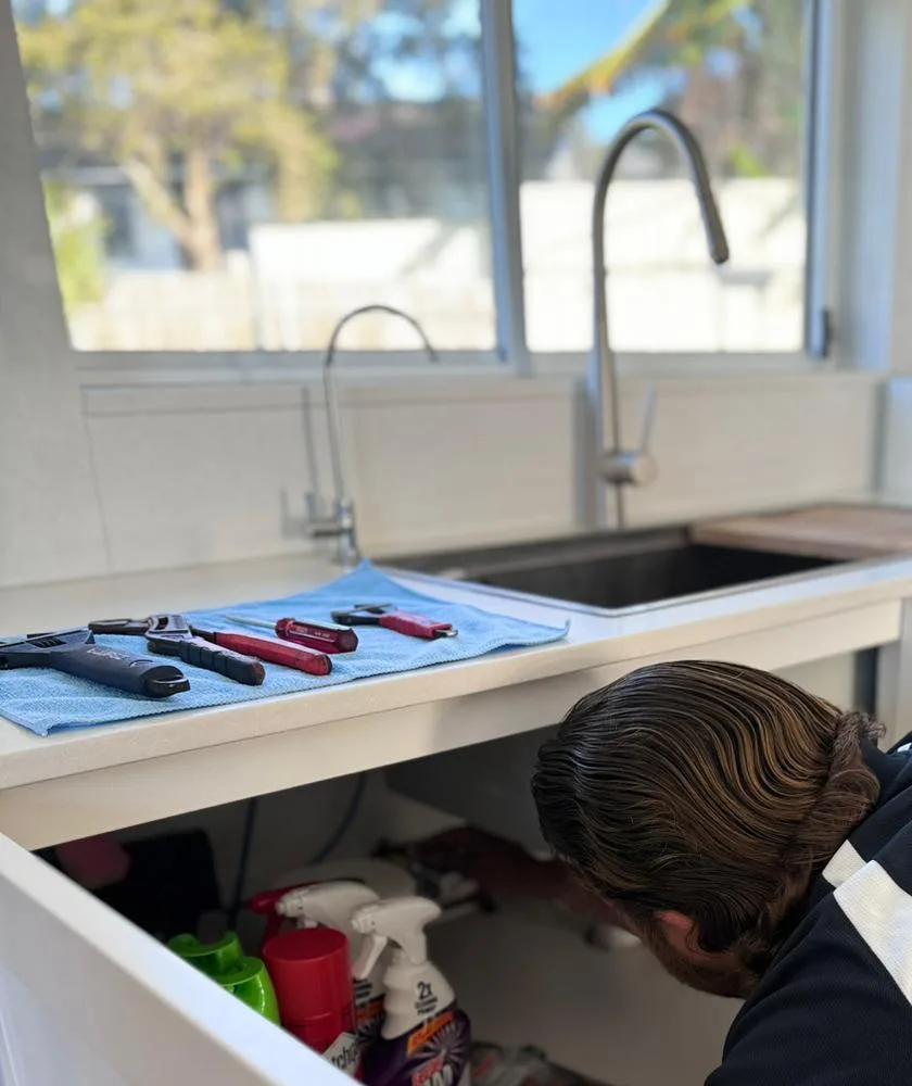 Tools laid out at the kitchen sink for a drain call-out